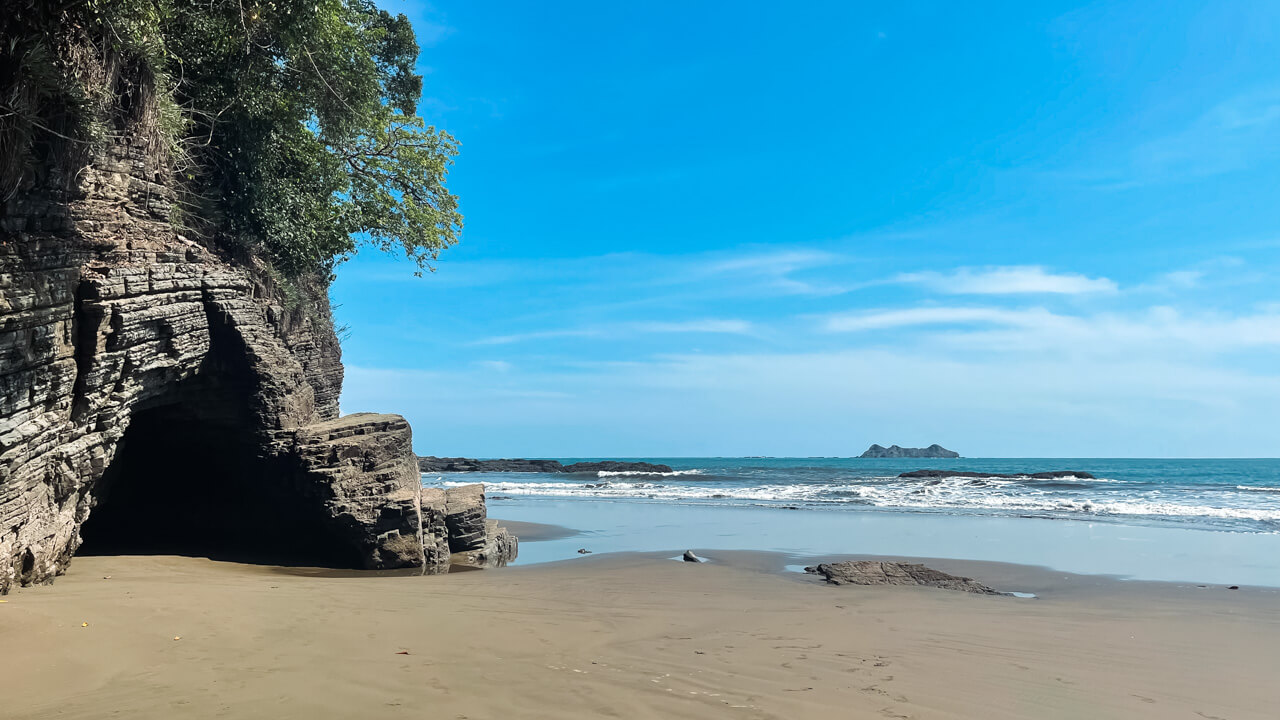 Playa Arco, a hidden beach in Uvita, Costa Rica, with caves and jungle on the beach.