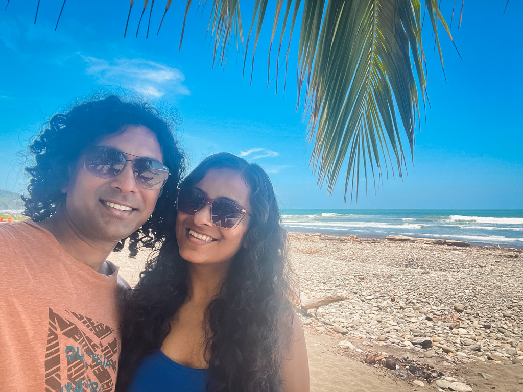 A couple posing for a selfie, at the Dominical Beach, while they were living by the beach in Costa Rica.