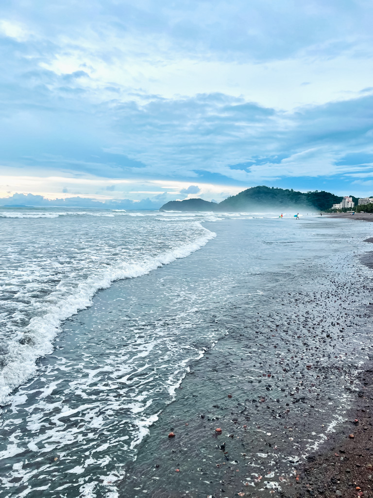 Jaco Beach, with surfers in the distance.