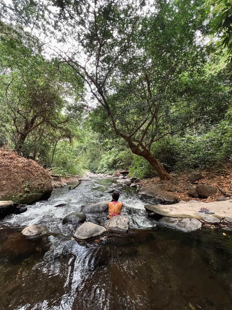 Woman sitting on a rock at the Tizate river.