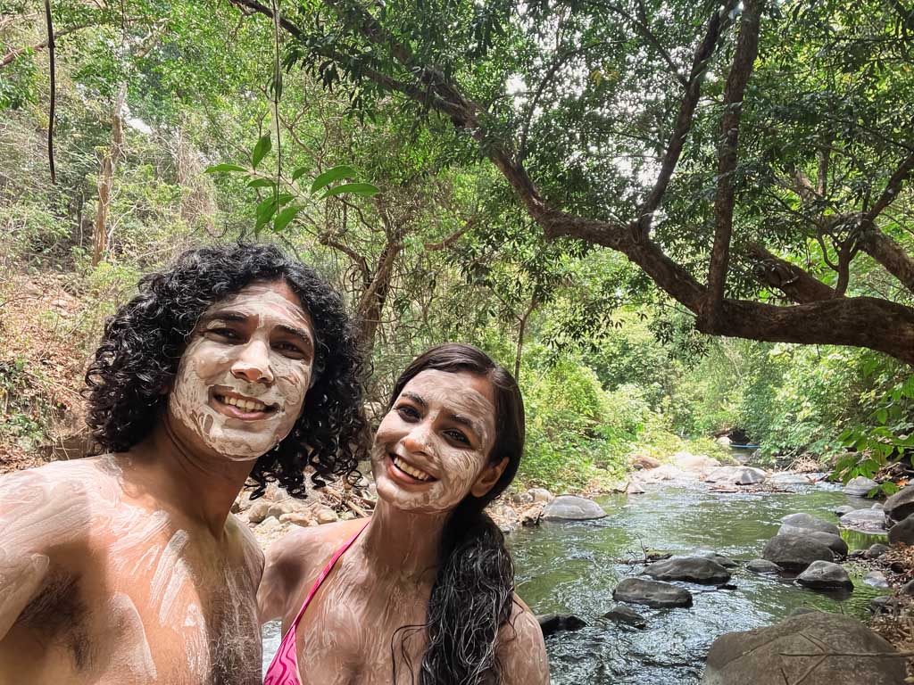 Couple posing for a selfie, with volcanic mineral mud on their skin.