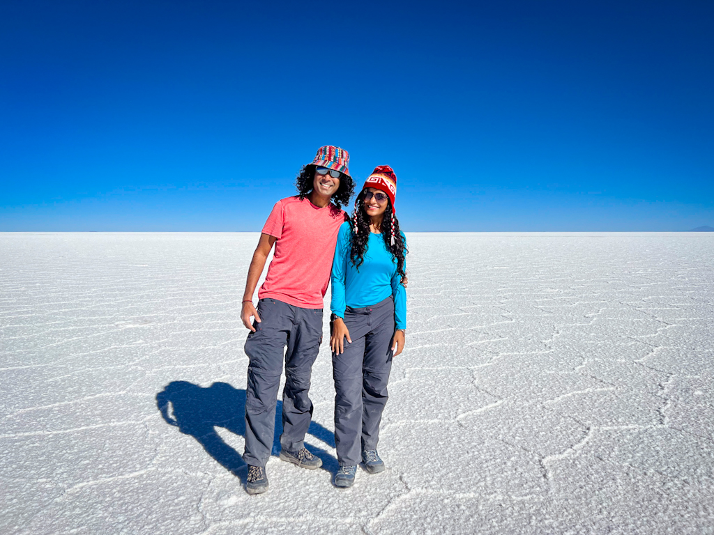 Couple standing on the Uyuni Salt Flats in Bolivia.