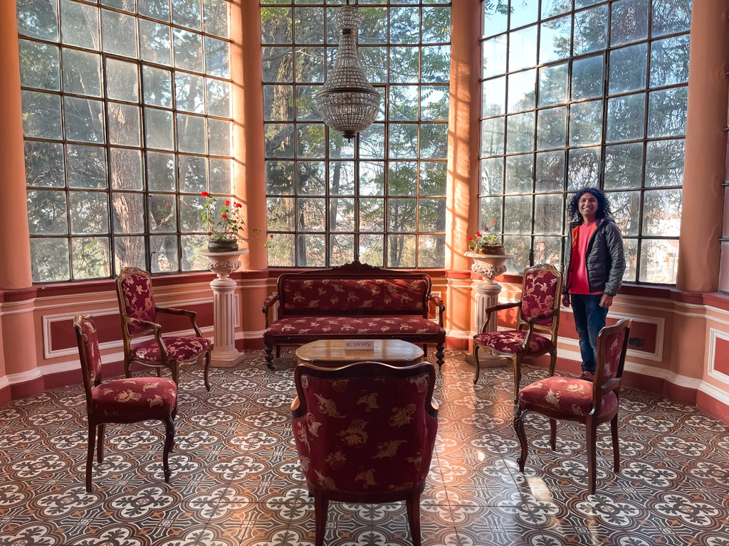 A man standing beside furniture in the Guereo Mansion.