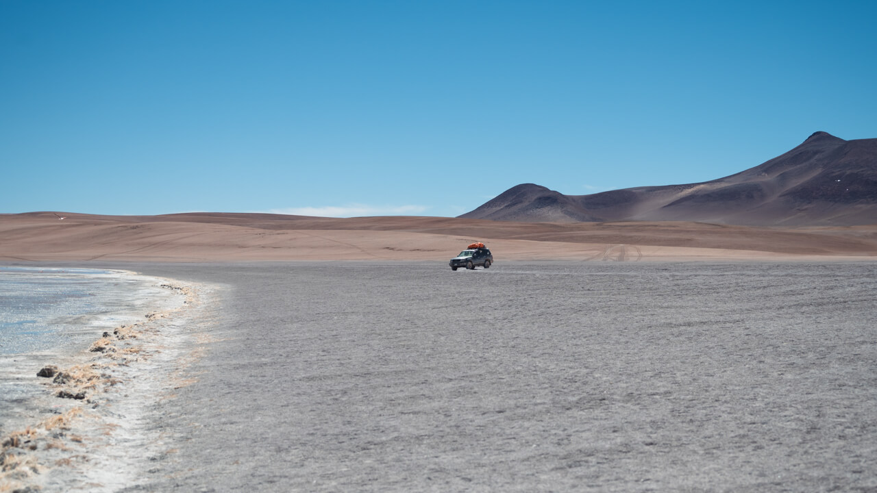 Vehicle in the vast landscape of the altiplano region of Bolivia.