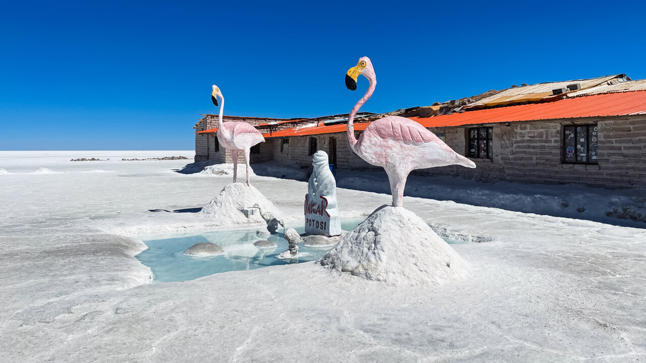 Heaps of salt and two statues of flamingoes near the Playa Blanca hotel on the salt flats of Uyuni.