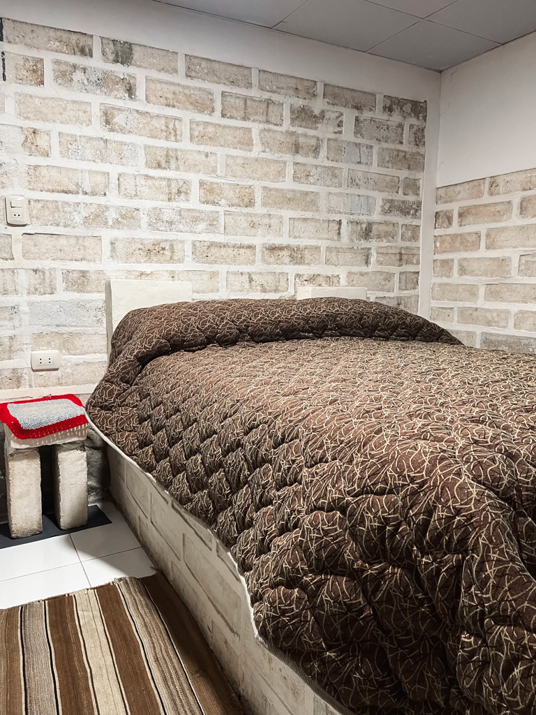 Private room in a salt hotel on the first night of Uyuni Salt Flats tour. Walls, bed, nightstand, all are made of salt.