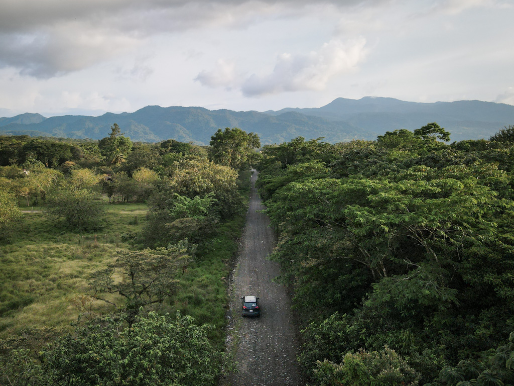 Aerial view of car driving on a road in Arenal.