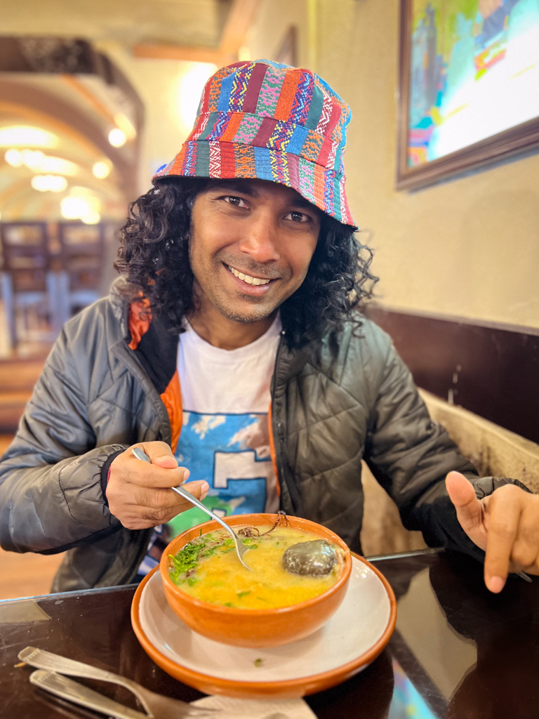 Man with his bowl of Kalapurka on the table.