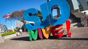 The SJO Vive sign in San Jose Costa Rica, where SJO is written in blue and VIVE in multiple colors.