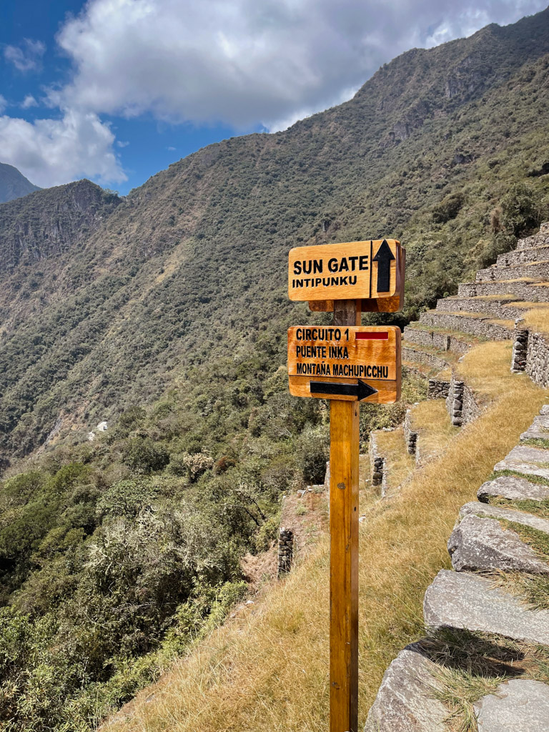 Signboard indicating the way to Inti Punku Sun Gate Machu Picchu.