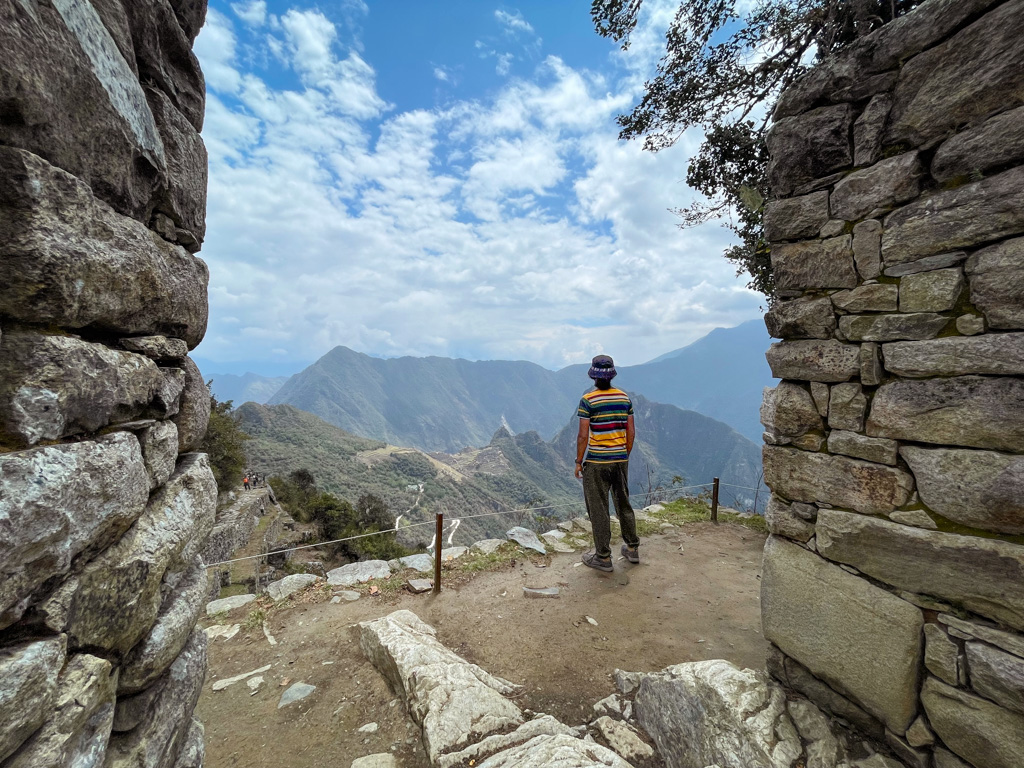 Man admiring the view from the Sun Gate at Machu Picchu.