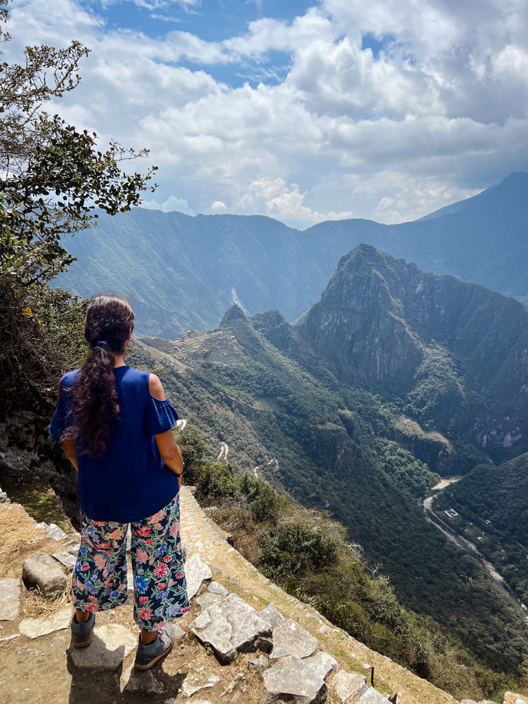 Woman, enjoying the view of Machu Picchu citadel from Inti Punku.