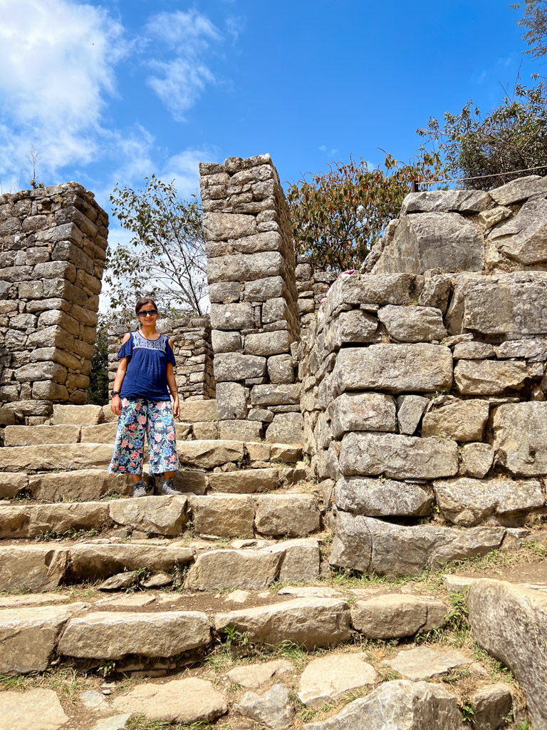 Womam standing at the Sun Gate of Machu Picchu, Inti Punku.