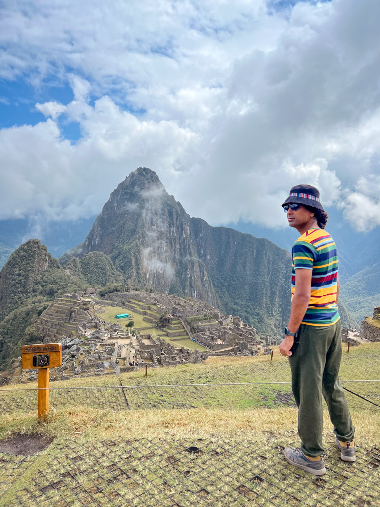 Man enjoying the clear weather view of Machu Picchu.