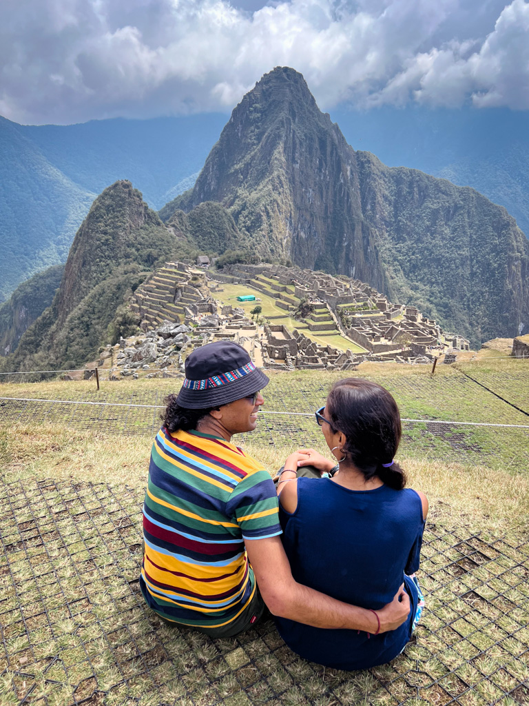 Couple enjoying a romantic moment while enjoying the view of Machu Picchu.