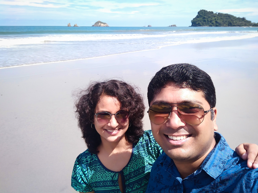 Couple on a morning walk at Espadilla Beach in Manuel Antonio.