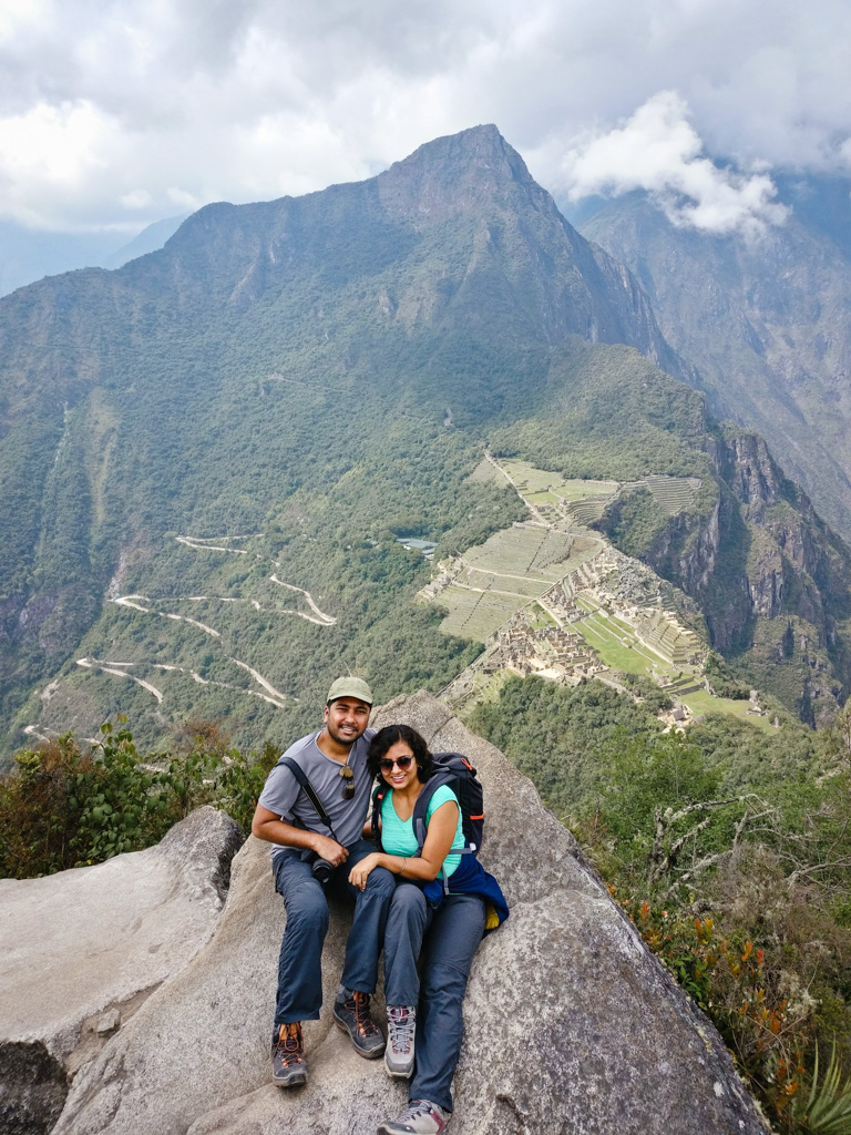 Couple at the summit of Huayna Picchu mountain, part of Circuit 3 while visiting Machu Picchu.