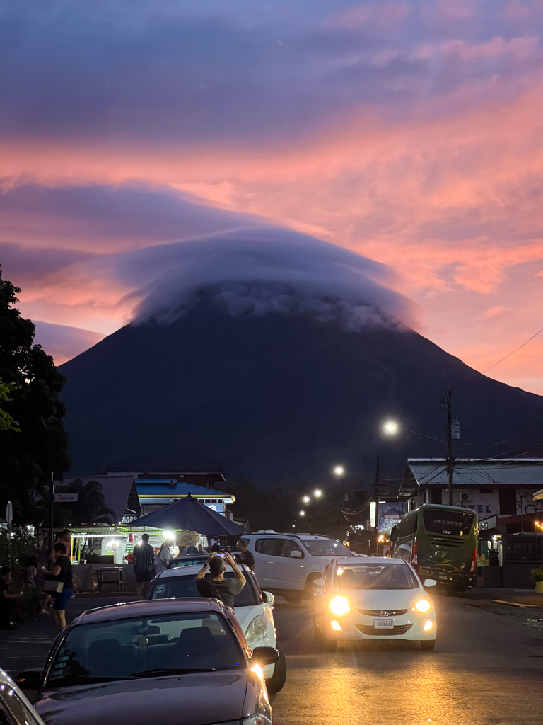 The Arenal Volcano, with its top covered in dense cloud, seen from the La Fortuna town center.